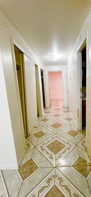 hall with light tile patterned floors