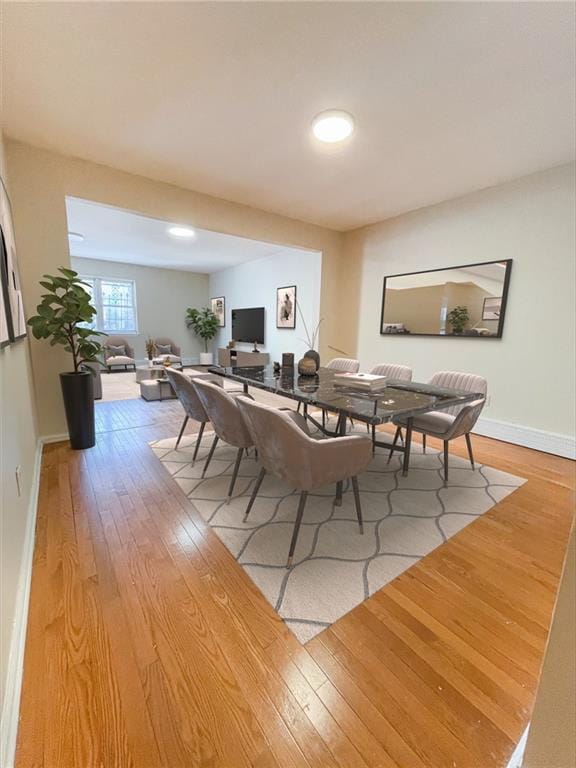 dining room featuring wood finished floors and baseboards