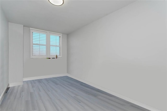 unfurnished room featuring light wood-style floors and baseboards