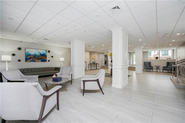 building lobby with a paneled ceiling and a surveillance system