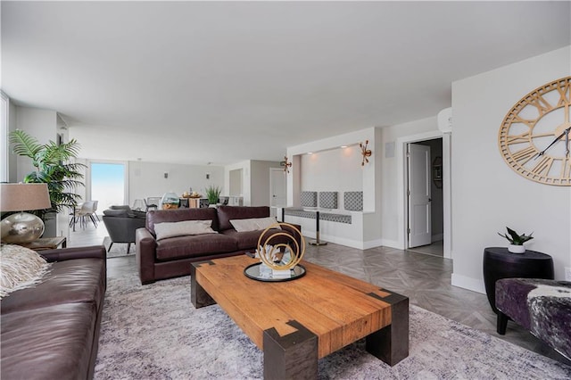 living area featuring baseboards and radiator