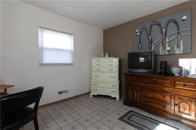 bedroom with tile patterned floors and baseboards