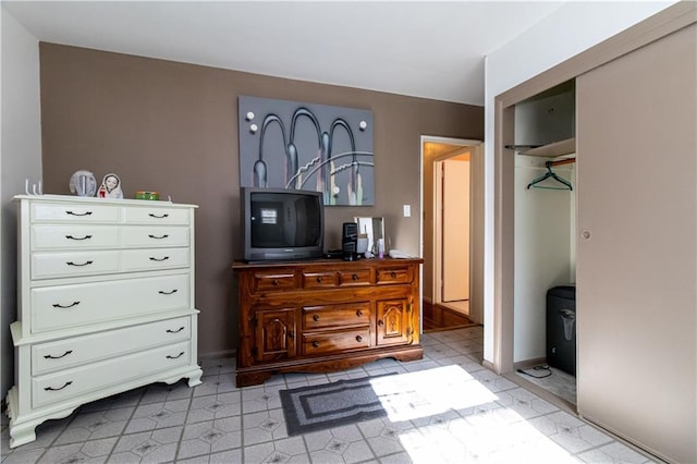 bedroom featuring light floors and a closet