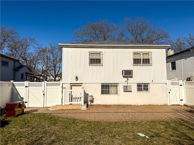 back of property featuring a gate, a patio area, and a fenced backyard