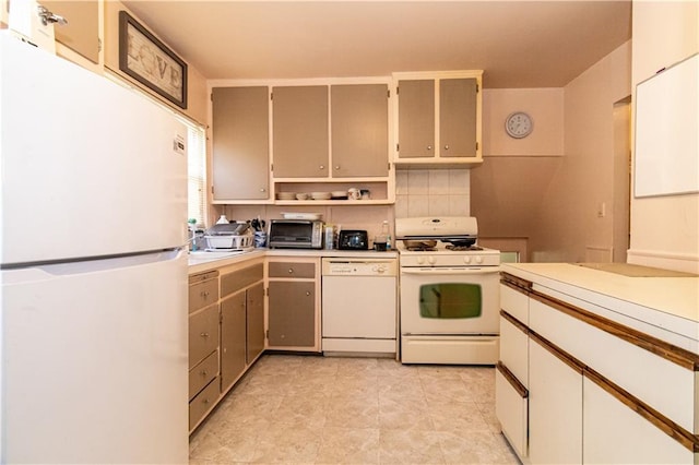 kitchen with white appliances, light countertops, and open shelves