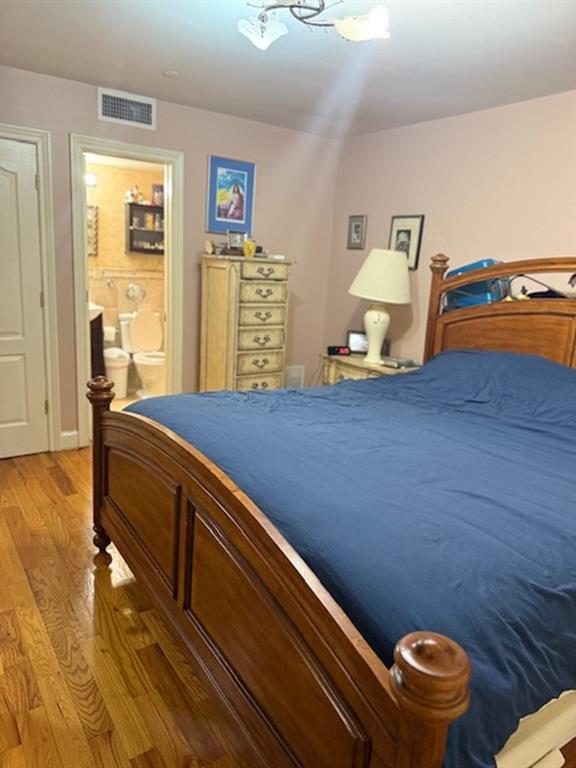 983 E 12th St Unit B, Brooklyn, NY 11230 - bedroom with light wood finished floors, a chandelier, and ensuite bath