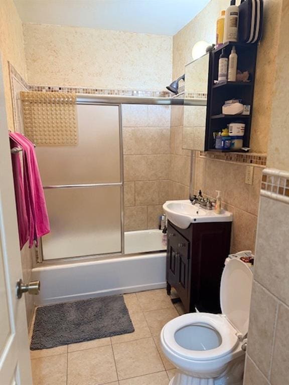 983 E 12th St Unit B, Brooklyn, NY 11230 - full bath featuring vanity, combined bath / shower with glass door, tile walls, toilet, and tile patterned flooring