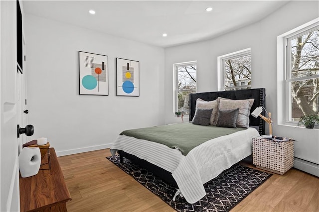213 E 9th St, Brooklyn, NY 11218 - bedroom featuring wood finished floors, recessed lighting, and a baseboard radiator