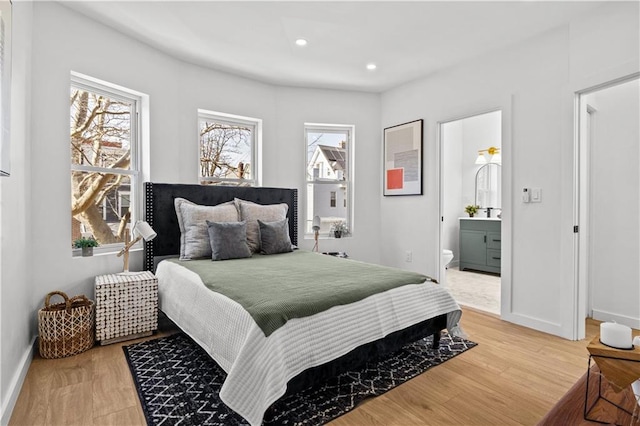 213 E 9th St, Brooklyn, NY 11218 - bedroom with connected bathroom, recessed lighting, and light wood-style flooring