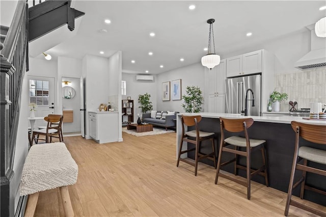 213 E 9th St, Brooklyn, NY 11218 - kitchen featuring high end fridge, an AC wall unit, light countertops, a breakfast bar area, and recessed lighting