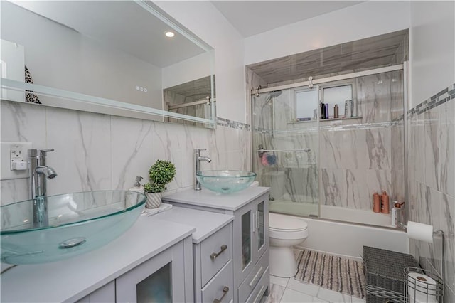 341 Hillman Ave, Staten Island, NY 10314 - full bath featuring tile walls, vanity, bath / shower combo with glass door, and toilet