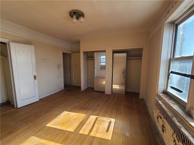40 Tehama St Unit 6H, Brooklyn, NY 11218 - unfurnished bedroom with hardwood / wood-style flooring, two closets, radiator, and baseboards