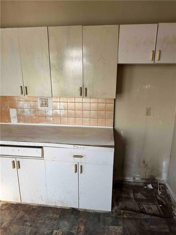 kitchen with light countertops and tasteful backsplash