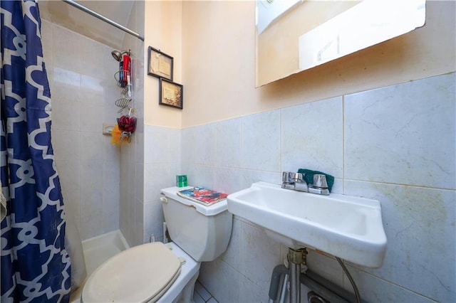 bathroom featuring toilet, a stall shower, and a sink