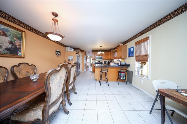 dining room featuring light tile patterned floors and baseboards