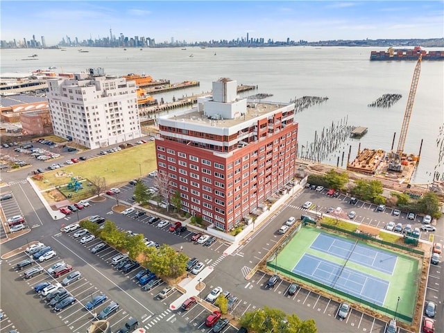 birds eye view of property with a view of city and a water view