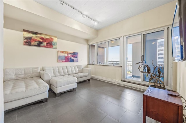 living room featuring track lighting and dark tile patterned floors