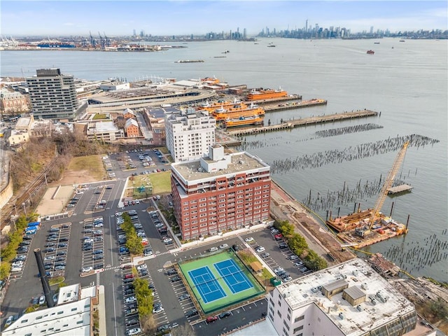 birds eye view of property featuring a water view and a city view