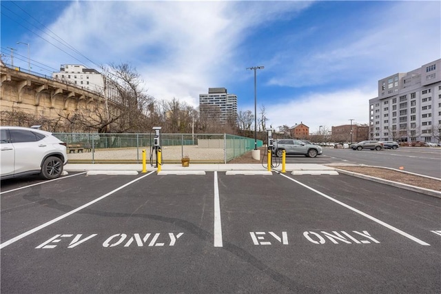 uncovered parking lot featuring fence