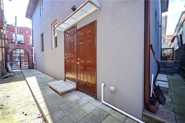 11 Brighton 10th Path, Brooklyn, NY 11235 - doorway to property featuring stucco siding and a gate