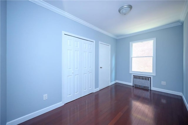 11 Brighton 10th Path, Brooklyn, NY 11235 - unfurnished bedroom featuring radiator heating unit, dark wood-style floors, crown molding, and a closet