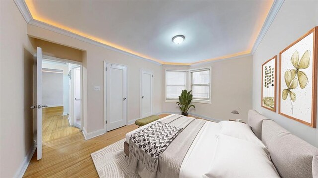 9281 Shore Rd Unit 220, Brooklyn, NY 11209 - bedroom featuring ornamental molding, light wood-style flooring, and baseboards