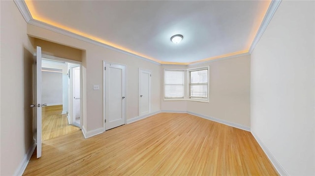 9281 Shore Rd Unit 220, Brooklyn, NY 11209 - unfurnished bedroom featuring crown molding, light wood finished floors, and baseboards