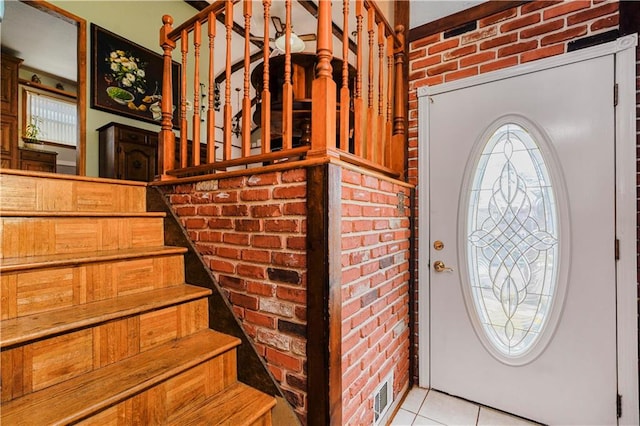 365 Buchanan Ave, Staten Island, NY 10314 - foyer featuring brick wall, stairway, and light tile patterned floors