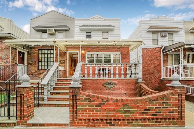 view of front of home with brick siding and a porch
