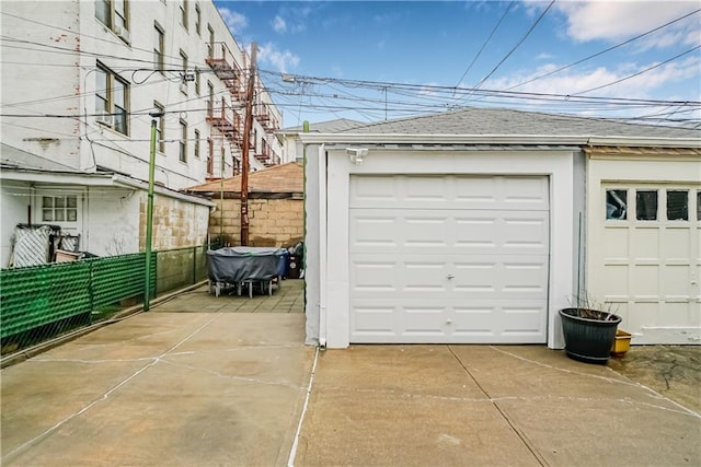 detached garage featuring fence