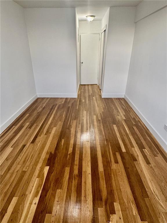 2800 Coyle St Unit 616, Sheepshead Bay, NY 11235 - spare room featuring wood-type flooring and baseboards