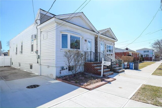 view of front of property with driveway and fence