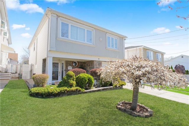 43 Fern Ave, Staten Island, NY 10308 - view of front facade featuring stone siding, a front lawn, and a gate