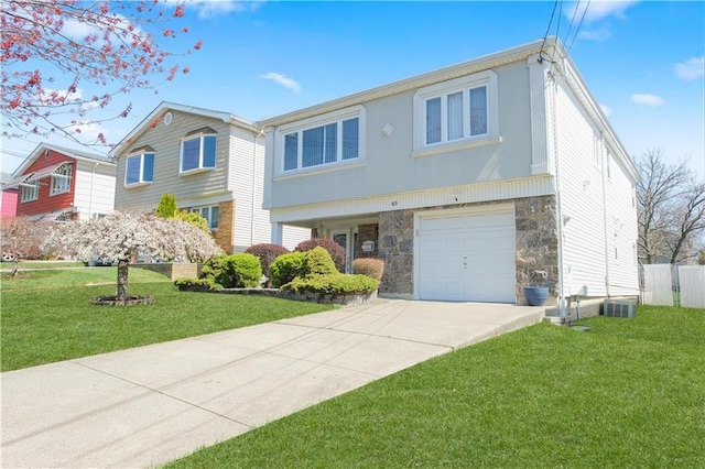 43 Fern Ave, Staten Island, NY 10308 - view of front of house featuring stone siding, concrete driveway, an attached garage, and central air condition unit