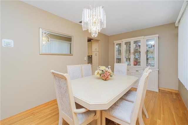 43 Fern Ave, Staten Island, NY 10308 - dining area featuring a chandelier, light wood finished floors, and baseboards