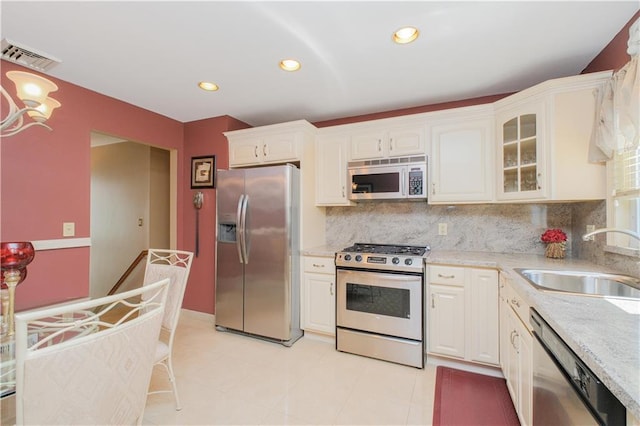 43 Fern Ave, Staten Island, NY 10308 - kitchen with stainless steel appliances, a sink, tasteful backsplash, white cabinetry, and glass insert cabinets