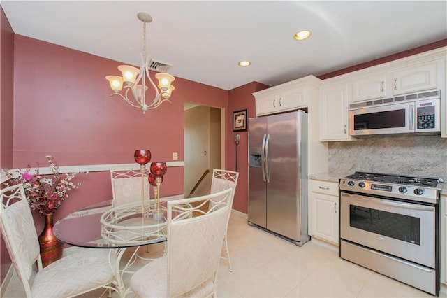43 Fern Ave, Staten Island, NY 10308 - kitchen with appliances with stainless steel finishes, a chandelier, white cabinets, decorative backsplash, and recessed lighting