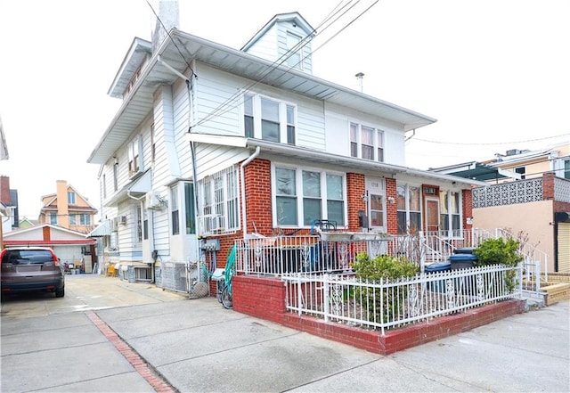 1718 W 11th St, Brooklyn, NY 11223 - view of front of home featuring a porch, a fenced front yard, central AC, a chimney, and brick siding