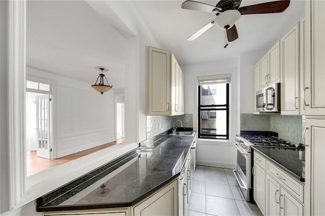 kitchen featuring stainless steel appliances, a healthy amount of sunlight, a sink, and tasteful backsplash