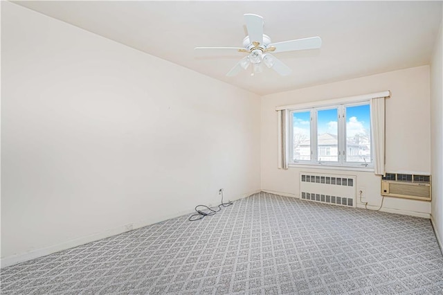 unfurnished room featuring radiator heating unit, carpet floors, a ceiling fan, and baseboards