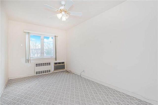 empty room featuring radiator, baseboards, ceiling fan, light carpet, and heating unit