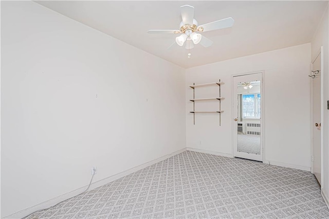 empty room with ceiling fan, light colored carpet, and baseboards