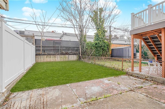 view of yard with stairway, a deck, and a patio area