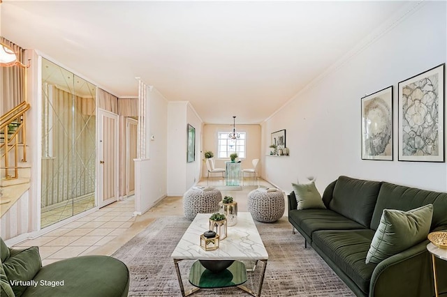 living room with ornamental molding, a chandelier, light tile patterned flooring, and baseboards
