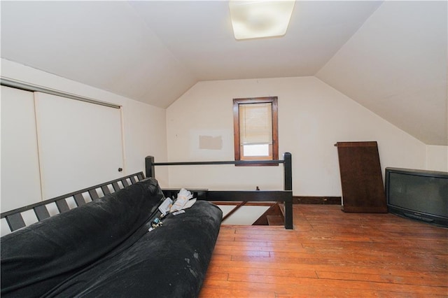 bonus room with wood-type flooring and lofted ceiling