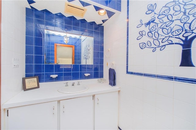 bathroom with tile walls and vanity