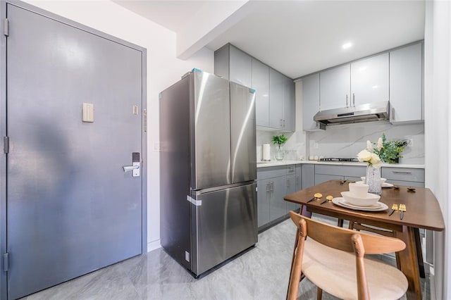 941 57th St Unit 1A, Brooklyn, NY 11219 - kitchen featuring freestanding refrigerator, under cabinet range hood, gray cabinets, and light countertops
