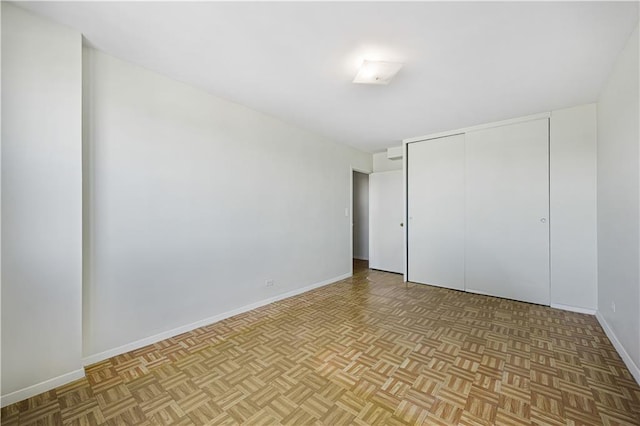 unfurnished bedroom featuring a closet and baseboards