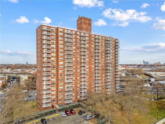 view of property with a view of city and uncovered parking
