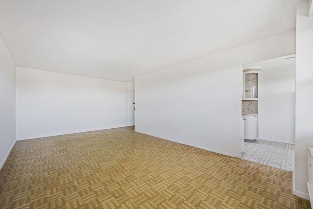 unfurnished room featuring baseboards